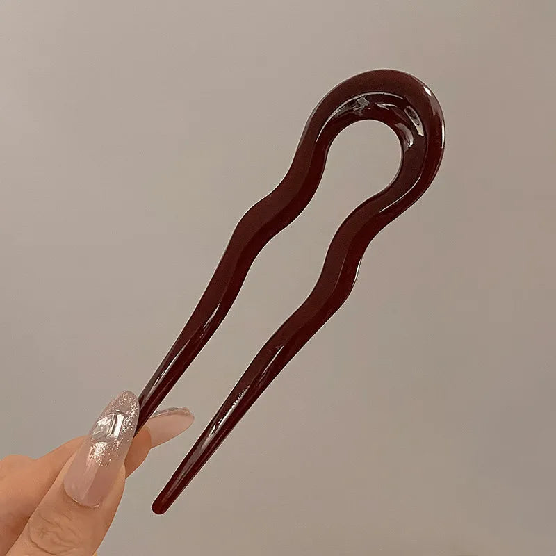 Burgundy French hair pin held between two fingers; the Duo includes 2 in this color
