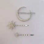 Close-up of a rhinestone moon clip and two star hair pins