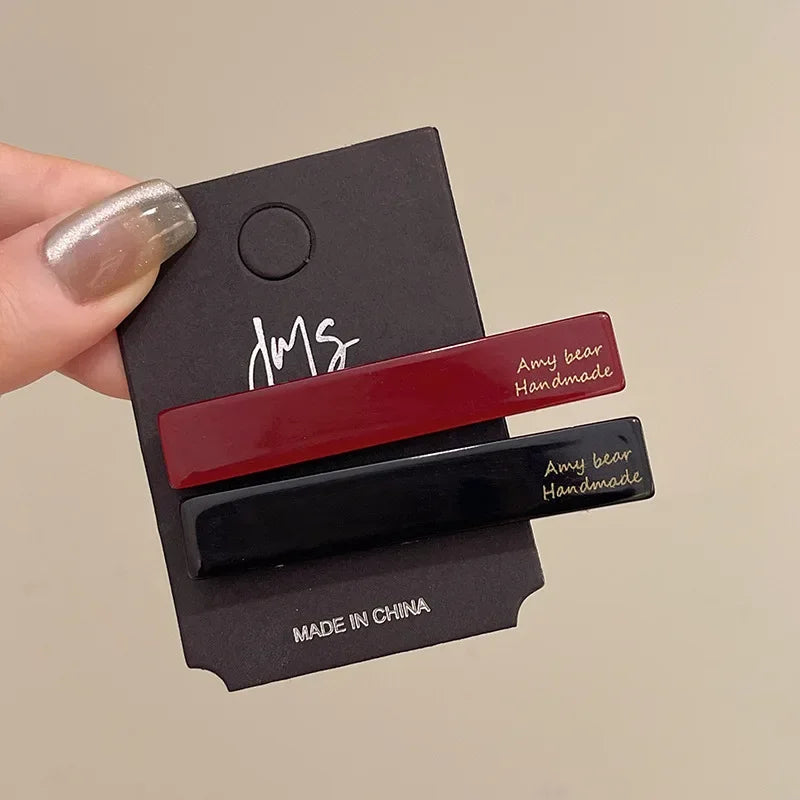 Geometric hair clips in burgundy and black, set of 2