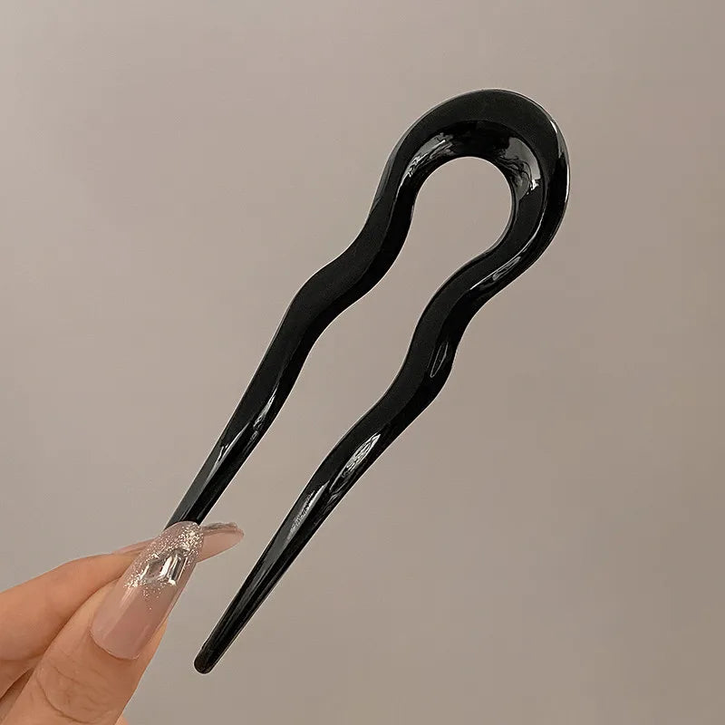 Glossy black French hair pin held between two fingers; the Duo includes 2 in this color
