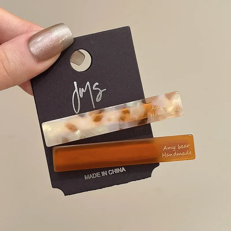 Set of 2 side clips in cream marble-look and amber