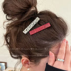 Dalmatian-print and red geometric clips worn beside a messy bun