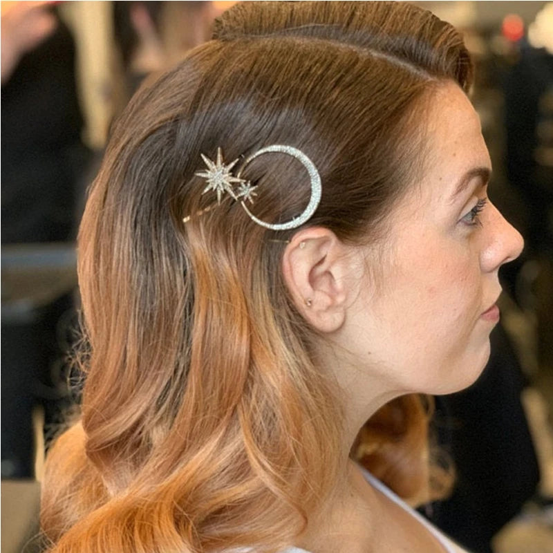 Rhinestone moon and star hair pins worn in a side half-up style
